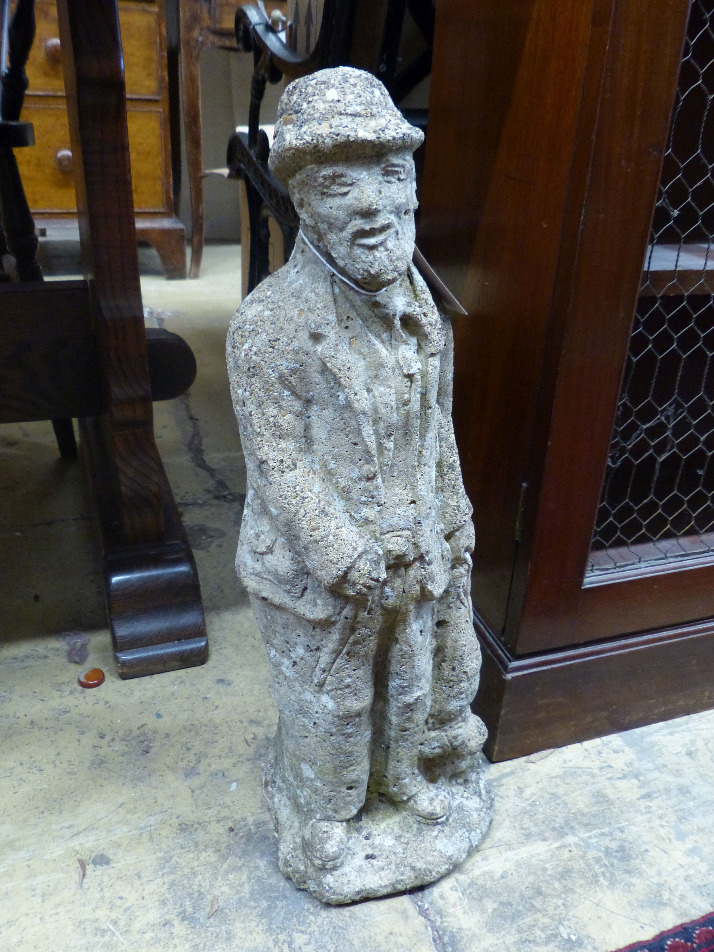 A reconstituted stone garden ornament of a standing figure, height 57cm